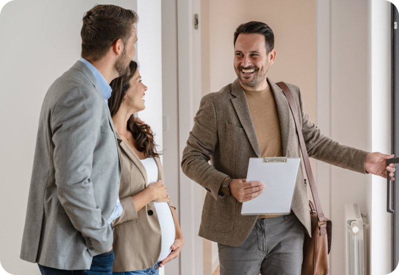 A realtor showing a couple around a home
